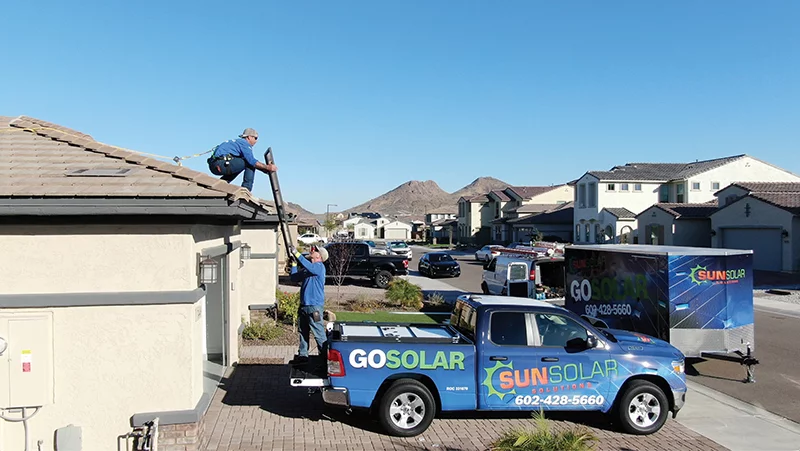 solar installers installing panels on a home