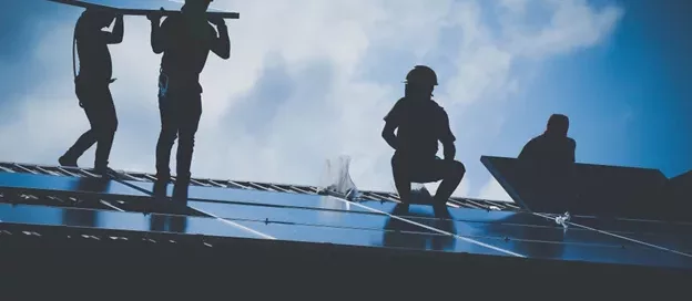 solar installers on a roof