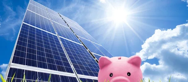 Piggy bank in front of solar panels