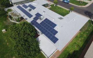 Aerial view of a residential property with solar panels installed by SUNSOLAR SOLUTIONS, showcasing sustainable energy solutions.